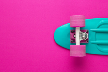 plastic mini cruiser board on deep pink with background with copy space © Ruslan Grumble