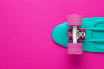 Poster plastic mini cruiser board on deep pink with background with copy space © Ruslan Grumble