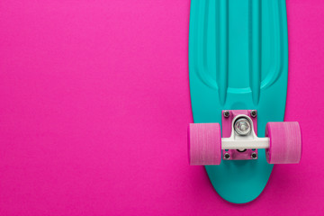 plastic mini cruiser board on deep pink with background with copy space