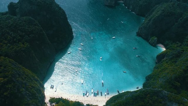 Aerial drone view of iconic tropical turquoise water Maya Bay surrounded by limestone cliffs, Phi Phi islands, Thailand