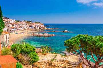 Sea landscape with Calella de Palafrugell, Catalonia, Spain near of Barcelona. Scenic fisherman village with nice sand beach and clear blue water in nice bay. Famous tourist destination in Costa Brava - obrazy, fototapety, plakaty