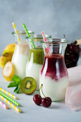 Set of fresh smoothies. Banana, cherries, kiwi and spinach for healthy eating, detox, diet food. Selective focus.