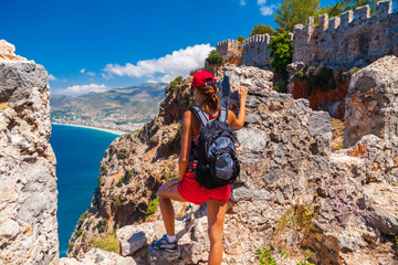 Young tourist woman look at ruins in Alanya peninsula, Antalya district, Turkey, Asia. Famous...