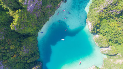 Aerial drone view of tropical turquoise water Loh Samah Bay surrounded by limestone cliffs, Phi Phi islands, Thailand