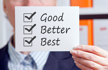 Good, Better, Best - Excellent Performance and Service - Manager with sign and checklist in the office