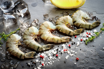 Raw tiger shrimps on gray stone
