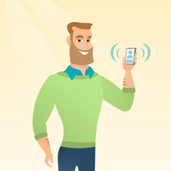 Young caucasian man holding ringing mobile phone.