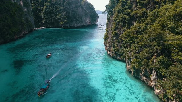 Aerial drone view of iconic tropical turquoise water Pileh Lagoon surrounded by limestone cliffs, Phi Phi islands, Thailand