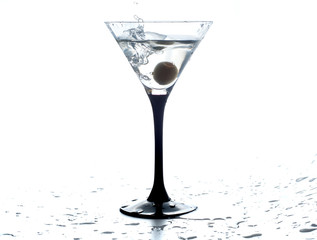 Cocktail martini with olive, a splash of vermouth in a glass