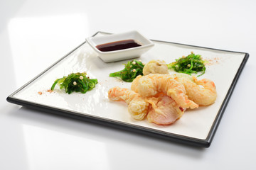 Tempura shrimps and vegetables with soy sauce, deep fried shrimps on white background
