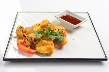 Baked vegetables in batter. White background, menu concept.