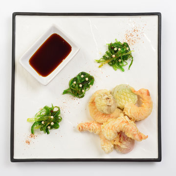 Tempura shrimps and vegetables with soy sauce, deep fried shrimps on white background