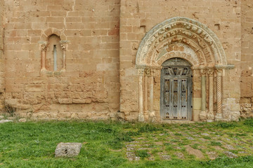 door and window of Romanesque church of Saint Andres in Soto of Bureba in the north of the province of Burgos, Spain