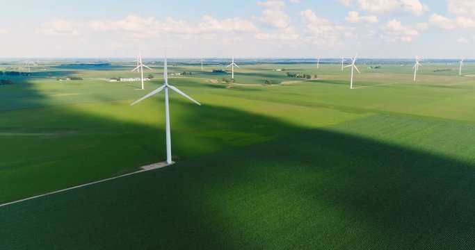 Wind turbine in a green field, top aerial view