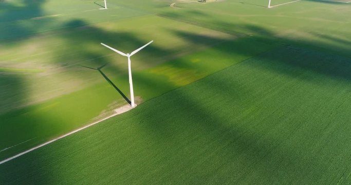 Wind turbine in a green field, top aerial view