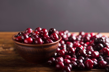 Cherries in a ceramic bowl. Ripe sweet cherry. Cherry. Cherry on a wooden background