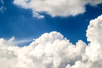 Blue vibrant sky with puffy white clouds