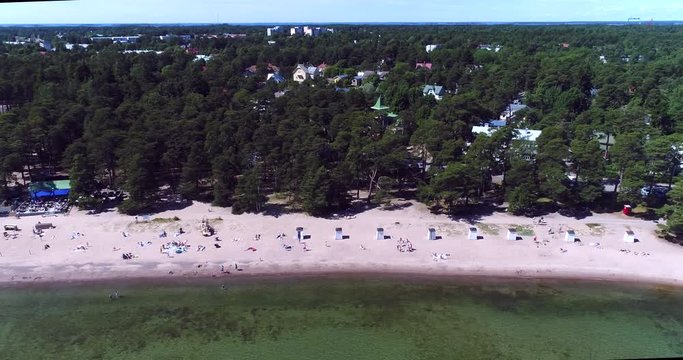 Hanko beach, Cinema 4k aerial sideway view of plagen beach, on hango regatta day, in the finnish archipelago city Hanko, Finland