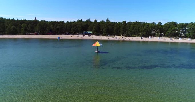 Hanko beach, Cinema 4k aerial view over the water carousel and plagen beach, revealing hango city, on regatta day, in the finnish archipelago city Hanko, Finland