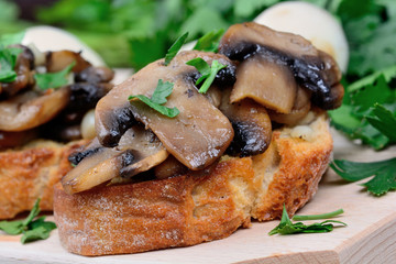 Bruschetta with mushroom on chopping board
