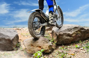 Gartenposter Trials motorcycle is jumping over rocks © toa555