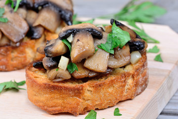 Bruschetta with mushroom and garlic on table