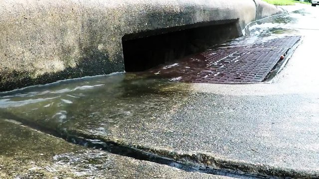 rain water flowing into a storm drain
