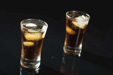 Alcohol drink coctail with ice on black