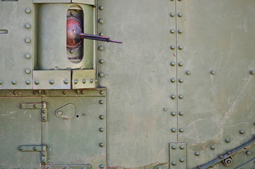 The texture of the wall of the tank, made of metal and reinforced with a multitude of bolts and rivets. Images of the covering of a combat vehicle from the Second World War with a guided machine gun