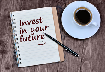 The words Invest in your future on notebook