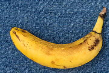 Single banana against denim background