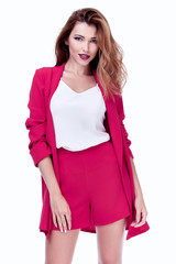 Beautiful sexy brunette woman business office style fashion clothes summer collection perfect body shape pretty face makeup smile wear short pink jacket silk blouse casual accessory glamour model.