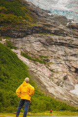 Tourist admiring Boyabreen Glacier in Norway