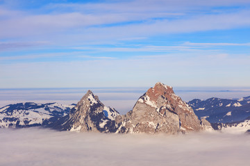 Summits of the Kleiner Mythen and Grosser Mythen mountains rising from a sea of fog