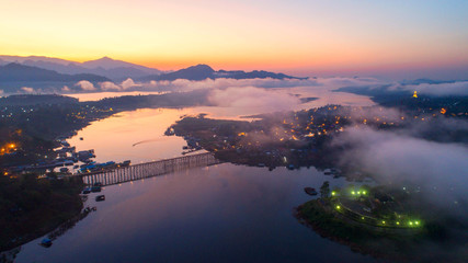 Aerial view and morning mist top view at Sangkhlaburi. It is a popular place for tourists. Images...