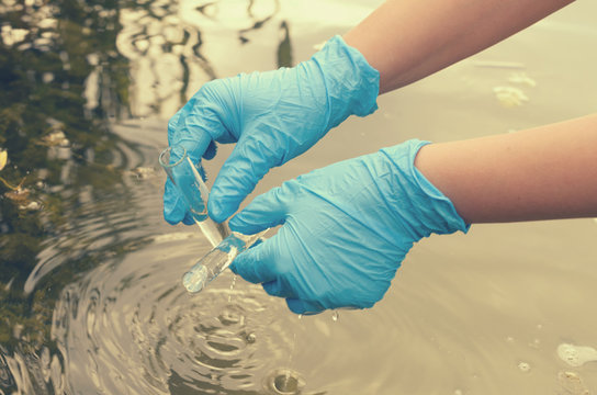 Taking a water test for analysis from a reservoir.