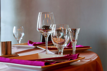 Glasses, flower fork, knife served for dinner in restaurant