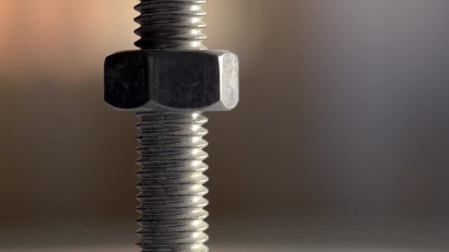 Close-up of screw and nut rotating