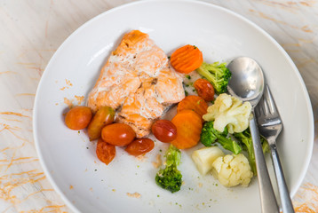 One piece of Grilled salmon steak with vegetables
