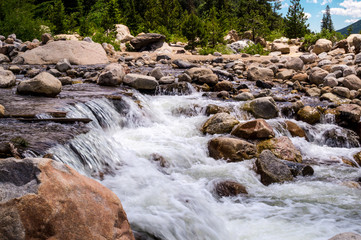 Fototapeta na wymiar Cobblestones and mountain stream. Rapid water flow