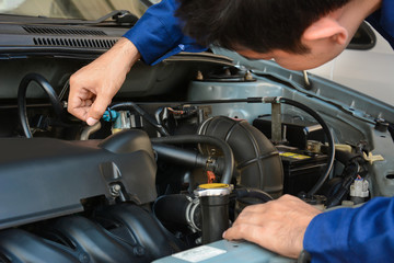 Auto mechanic checking car engine