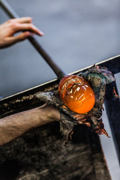 Man Hands Closeup Working on a Blown Glass Piece