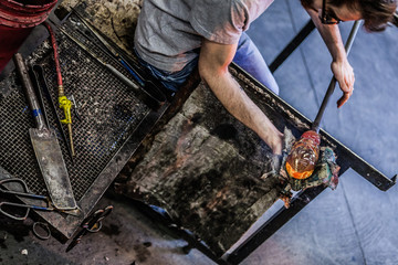 Man Hands Closeup Working on a Blown Glass Piece