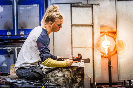 Blowing Glass Professional Woman Working on a Vase.