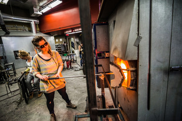 Glassmaker Flashing Piece of Glass in the Kiln