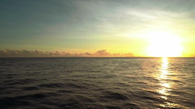 Sunrise above ocean from boat, horizontal panorama, Siargao, Philippines