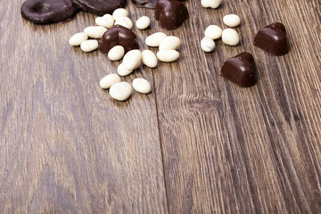 Fototapeta na wymiar Heart shape chocolate on wooden background in studio photo