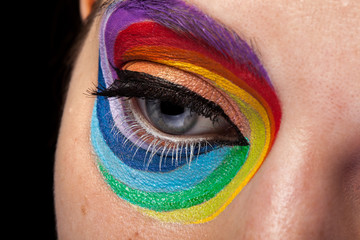 Naklejka premium Eye in close up with artistic rainbow make up. Beauty image