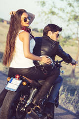 Sexy couple of bikers on the vintage custom motorcycle