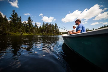 Foto op Plexiglas Sun and Father Fishing in a Calm Lake in Wild Nature. © aetb